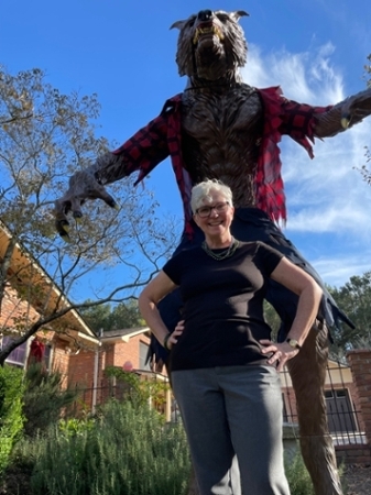 Dr. Crystal O’Leary Davidson, MGA English professor, poses with a giant werewolf statue.